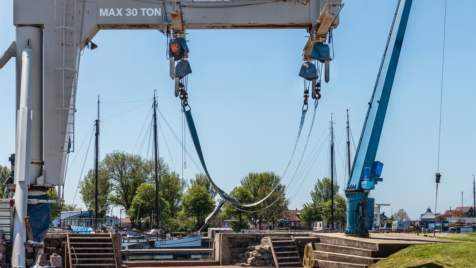 Boat lifted by a yard crane at the quayside